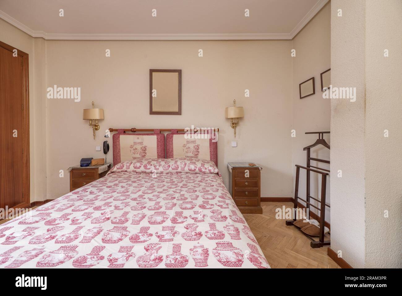 a bedroom with a double bed with an upholstered headboard, a matching ...