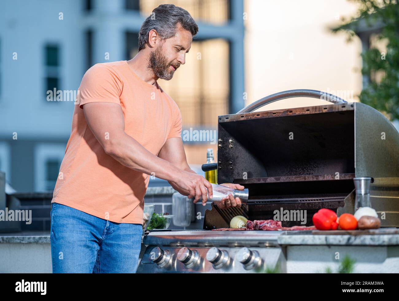 Grilling man cook meat at barbecue. Charcoal grilling expertise