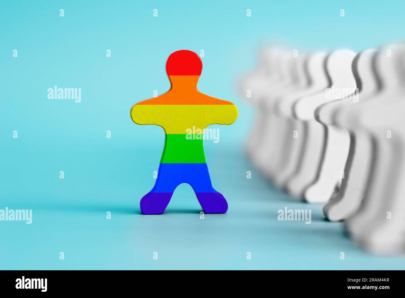 A lot of white figurines and one colored figurine as symbol of diversity Stock Photo