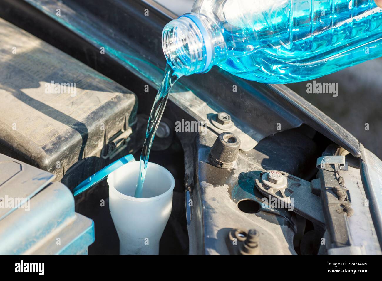 Filling the windshield washer fluid on a car Stock Photo Alamy