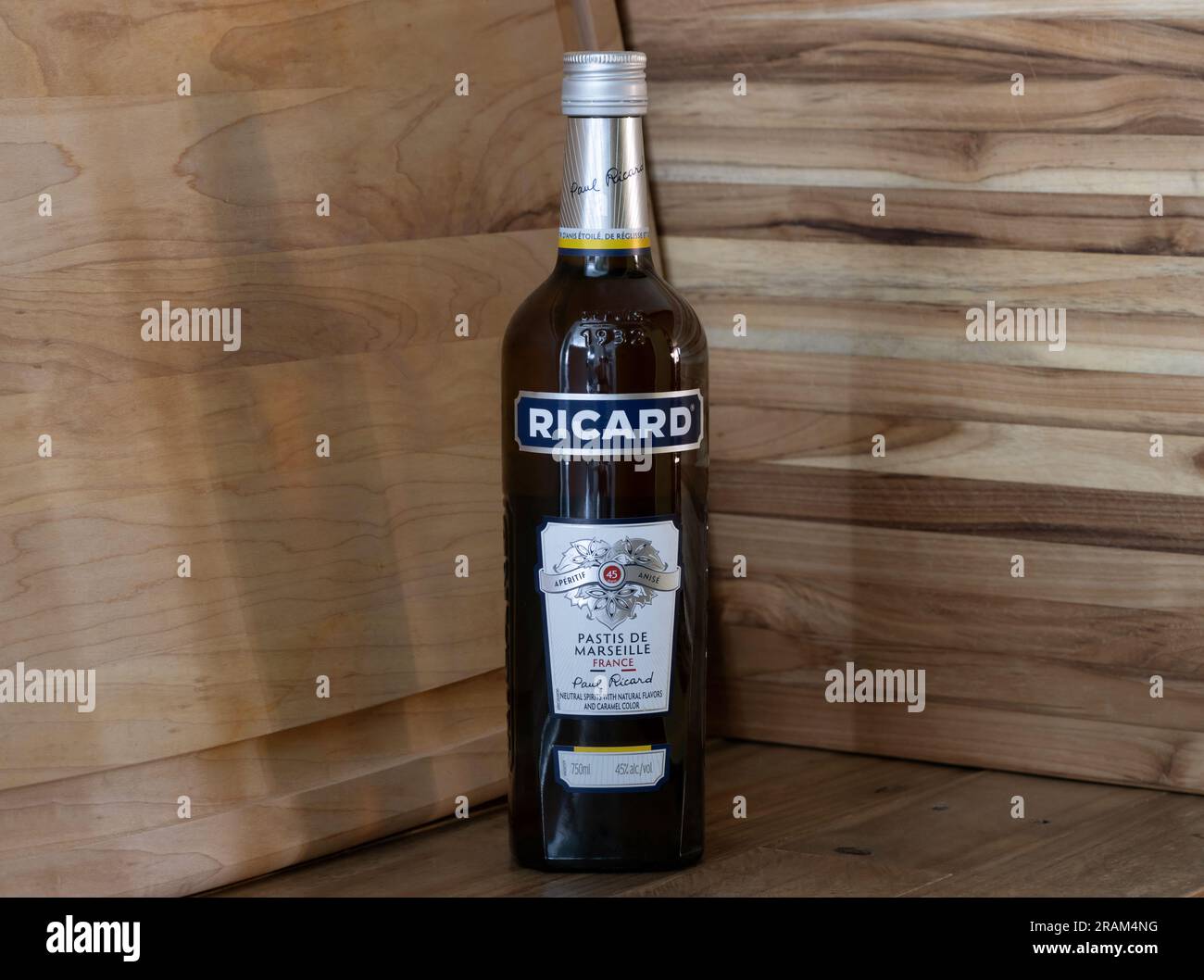 https://c8.alamy.com/comp/2RAM4NG/bottle-of-ricard-pastis-anise-and-licorice-flavored-aperitif-liquor-from-marseilles-on-a-rustic-wood-background-2RAM4NG.jpg