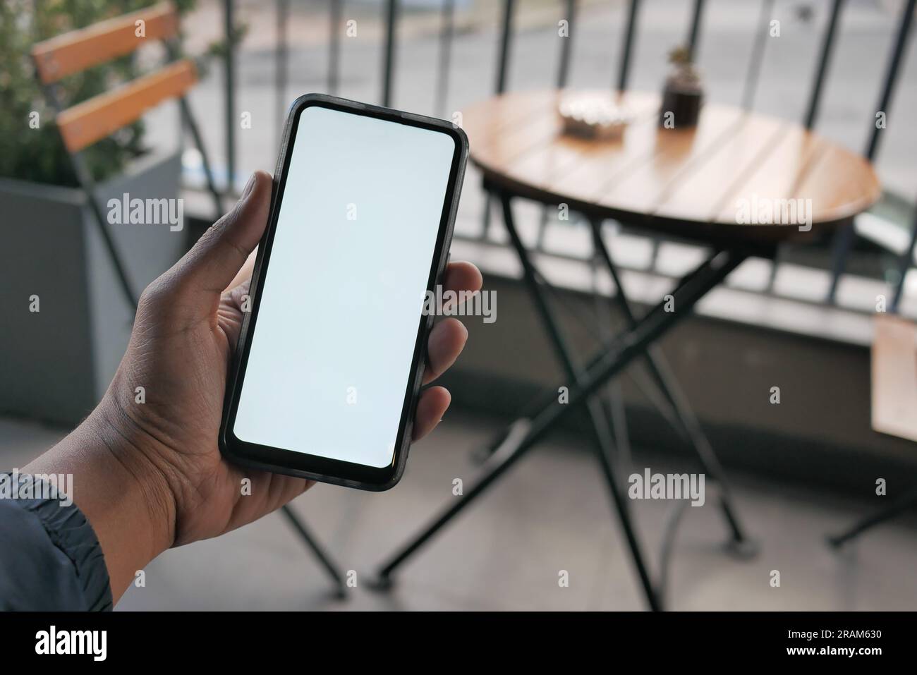 young man hand using smart phone with green screen at cafe Stock Photo ...