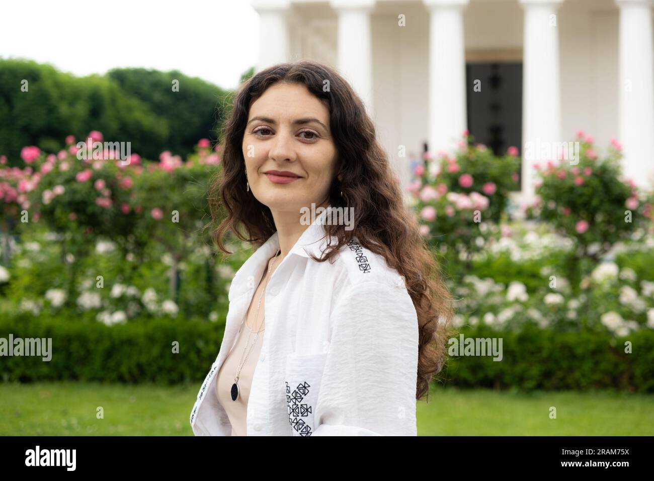 Beautiful successful 35-year-old woman in white shirt walking in the ...