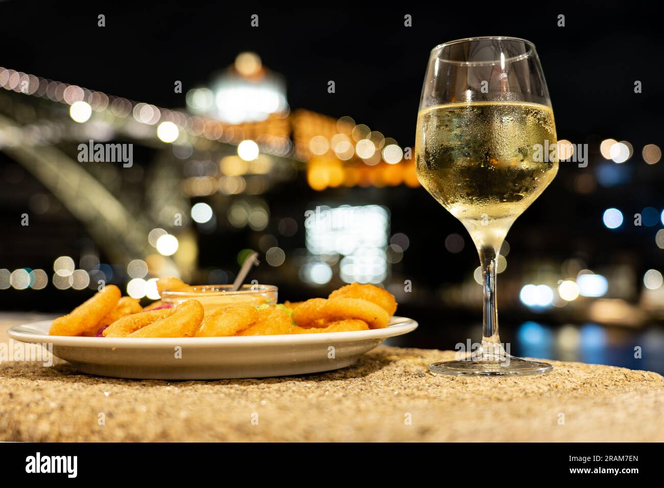 eating fried calamari dinner and drinking white port wine in a restaurant in Porto next to the