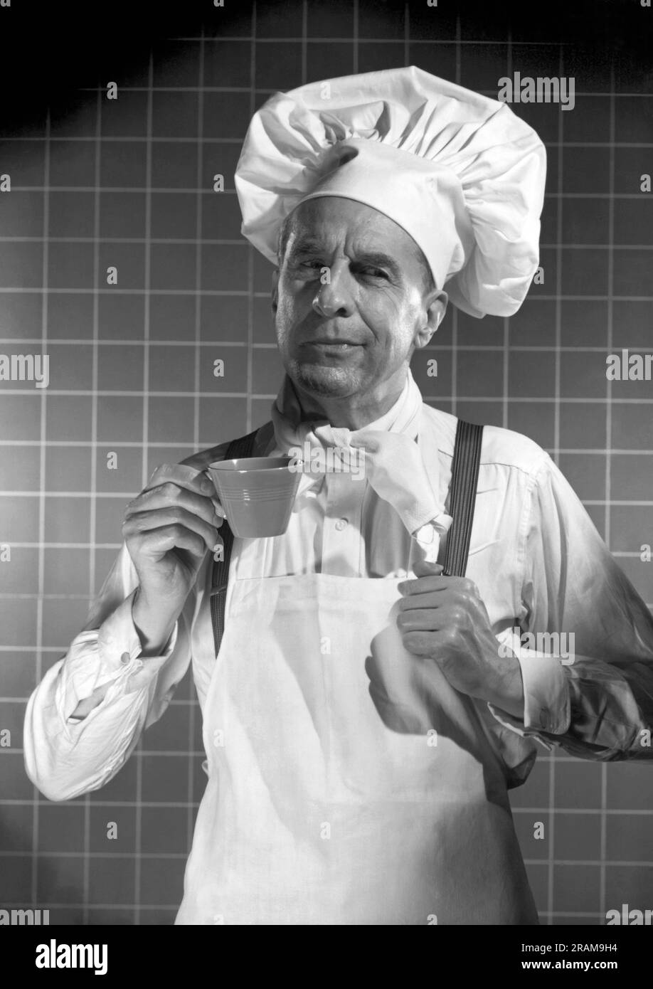 United States:  c. 1948 A portrait of a chef holding a coffee cup. Stock Photo