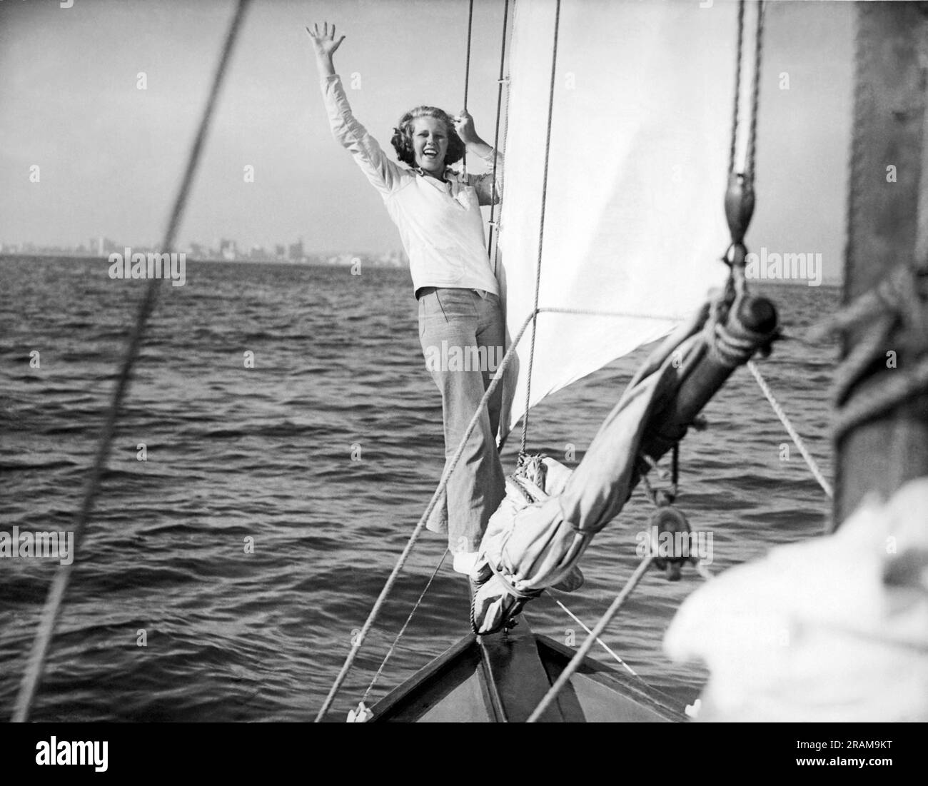 Long Beach, California: c. 1936. A woman on the bow sprit signals that ...