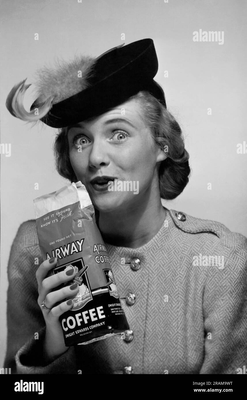 United States:  c. 1946 A stylish woman holding up a bag of Airways Coffee. Stock Photo