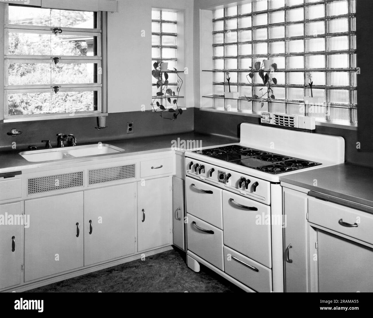 Milwaukee, Wisconsin:  c. 1950 A kitchen in a home with modern appliances and glass block windows. Stock Photo