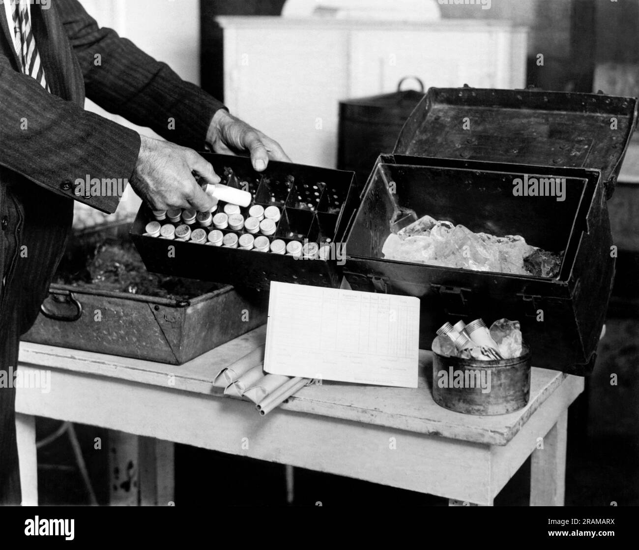 New York, New York:  c. 1926 A New York City Health Department Inspector's milk sample outfit. The milk samples at the left are constantly kept on ice so that accurate tests may be made of them in the laboratory. Stock Photo