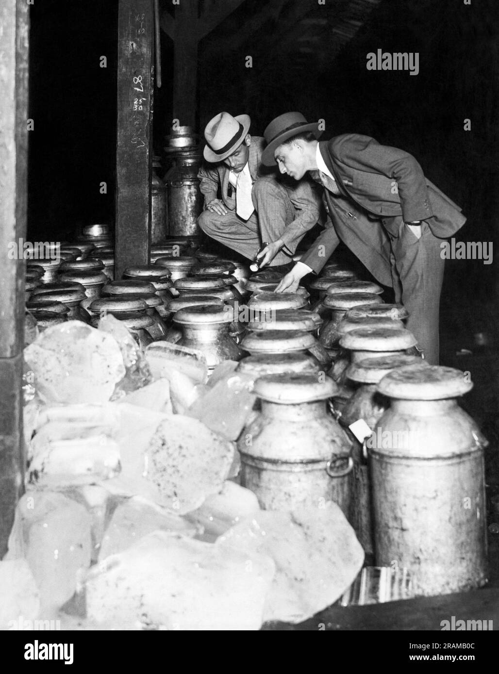 New York, New York:  c. 1929 Two New York City Department of Health Inspectors checking sources of milk arriving on a railroad milk platform. Stock Photo