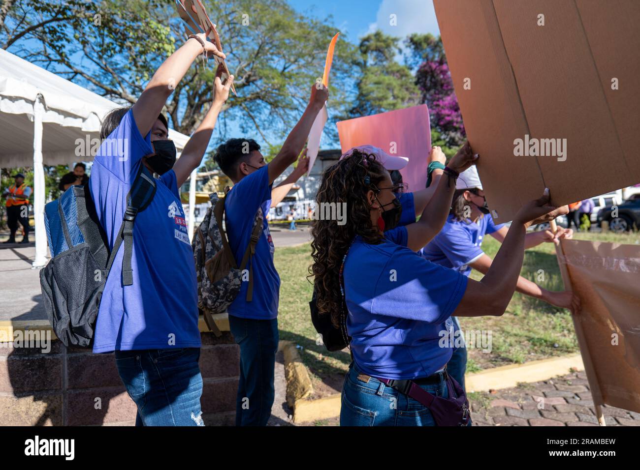 Tegucigalpa, Francisco Morazan, Honduras - December 11, 2022: Young Brown Adults Hold Cardboard Signs at Protest for the International Day for the Eli Stock Photo