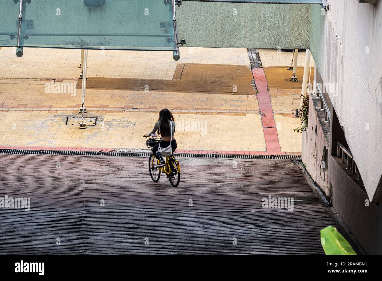 Putrajaya, Malaysia--March 31, 2023. A girl rides her bicycle down a ...