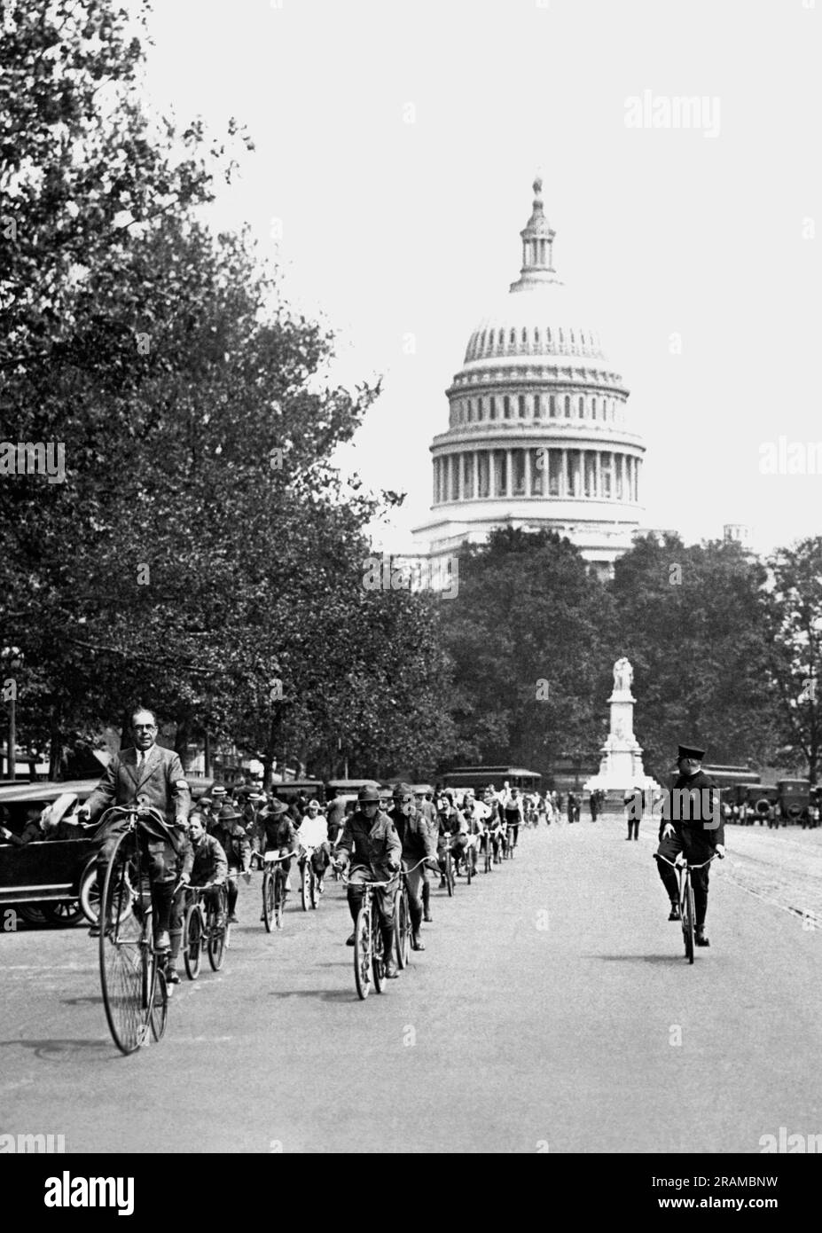 Washington, D.C.:  May 19, 1924 Bicycle enthusiasts remembering the old days of the bicycle craze take their yearly get together up Pennsylvania Avenue. All of Washington stopped to watch them. Stock Photo