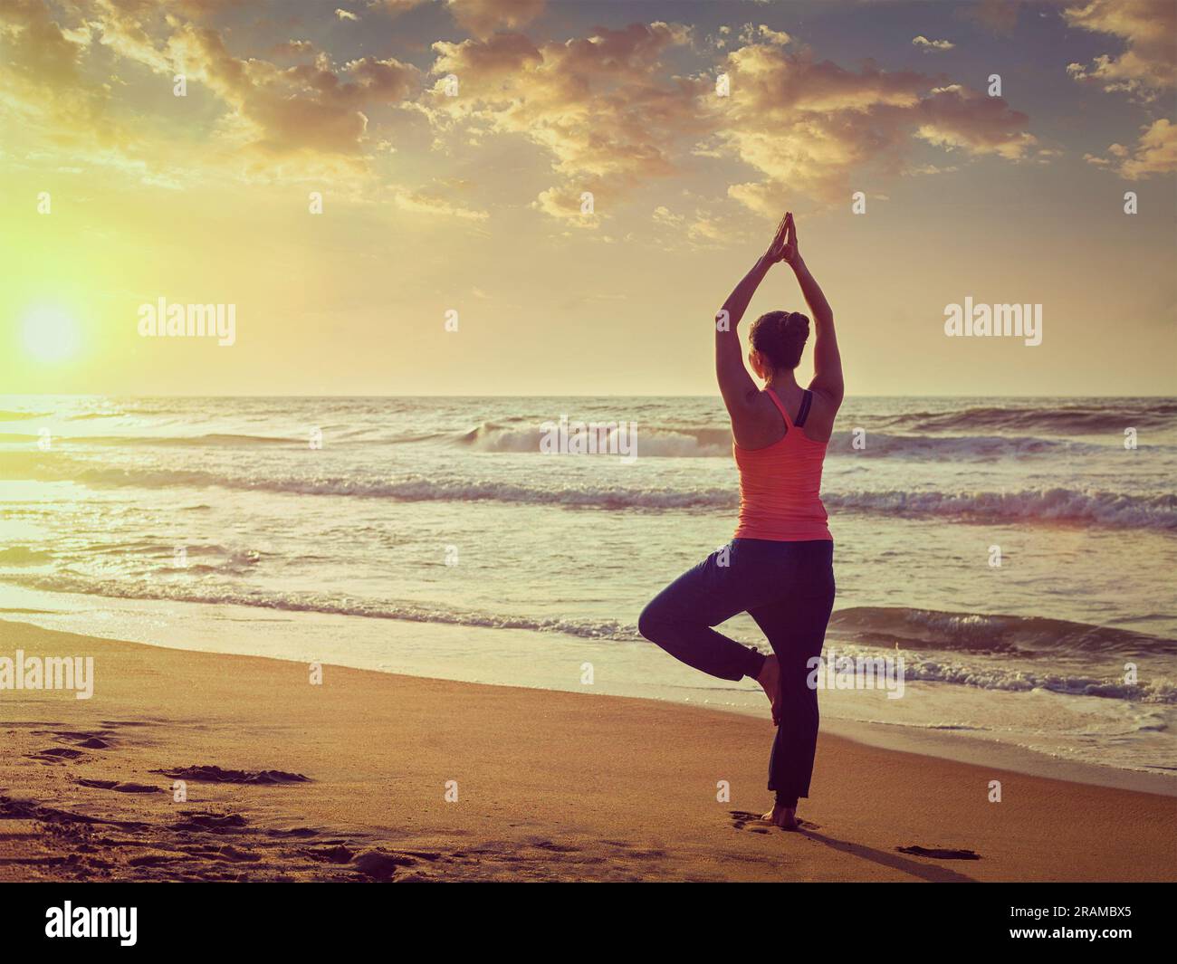 Young woman tree position beach hi-res stock photography and images - Alamy