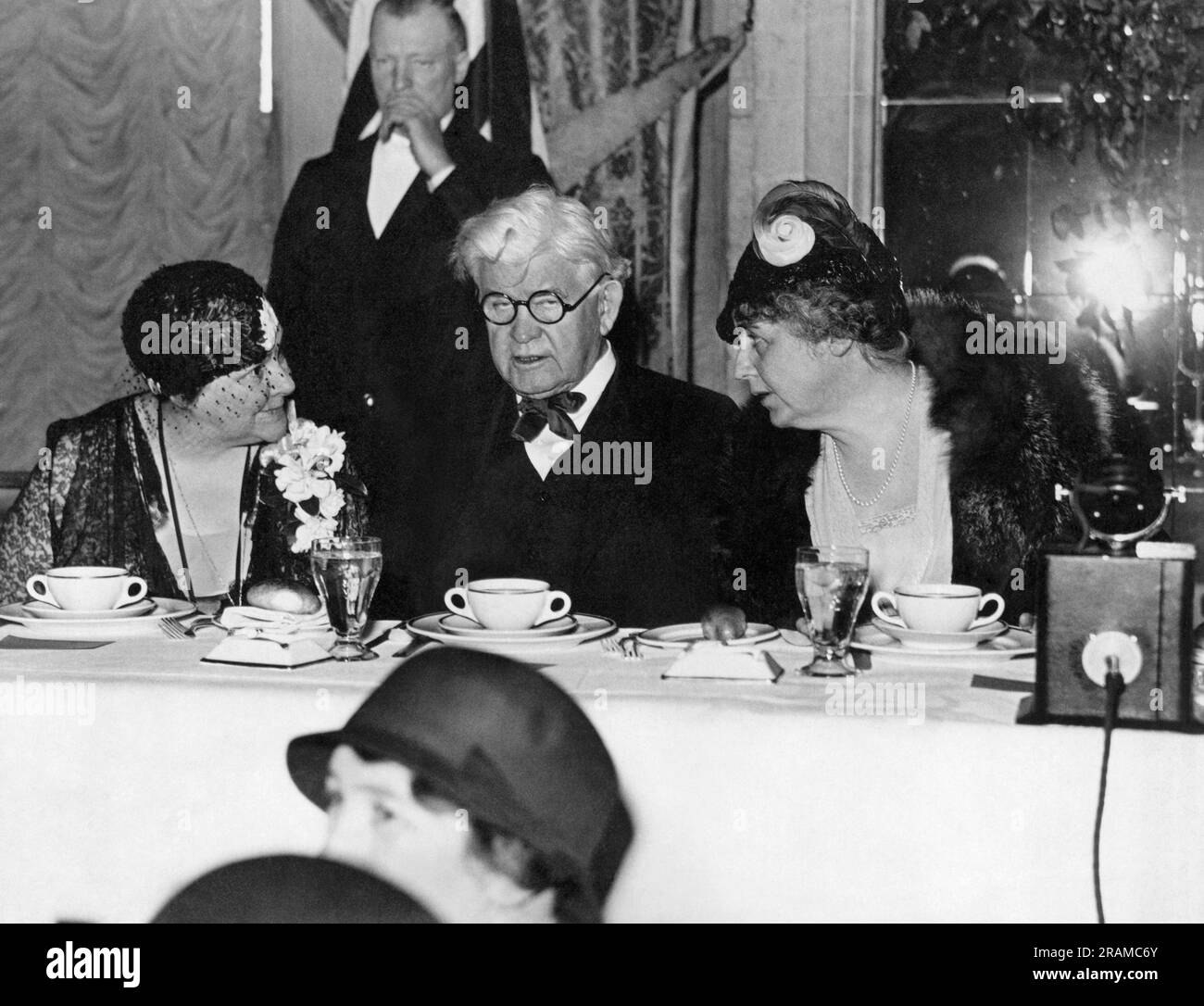 Washington, D.C.:   c. 1929 House leader Representative Henry Rainey chats with Democratic New Jersey Rep. Mary Norton, (L) and Mrs. Woodrow Wilson, widow of the ex-President at the Willard Hotel. Stock Photo