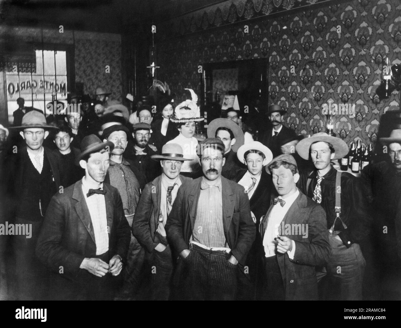 Dawson City, Yukon Territory, Canada:  c. 1898 The interior of the Monte Carlo Saloon in Dawson City with its numerous men and two women. Stock Photo