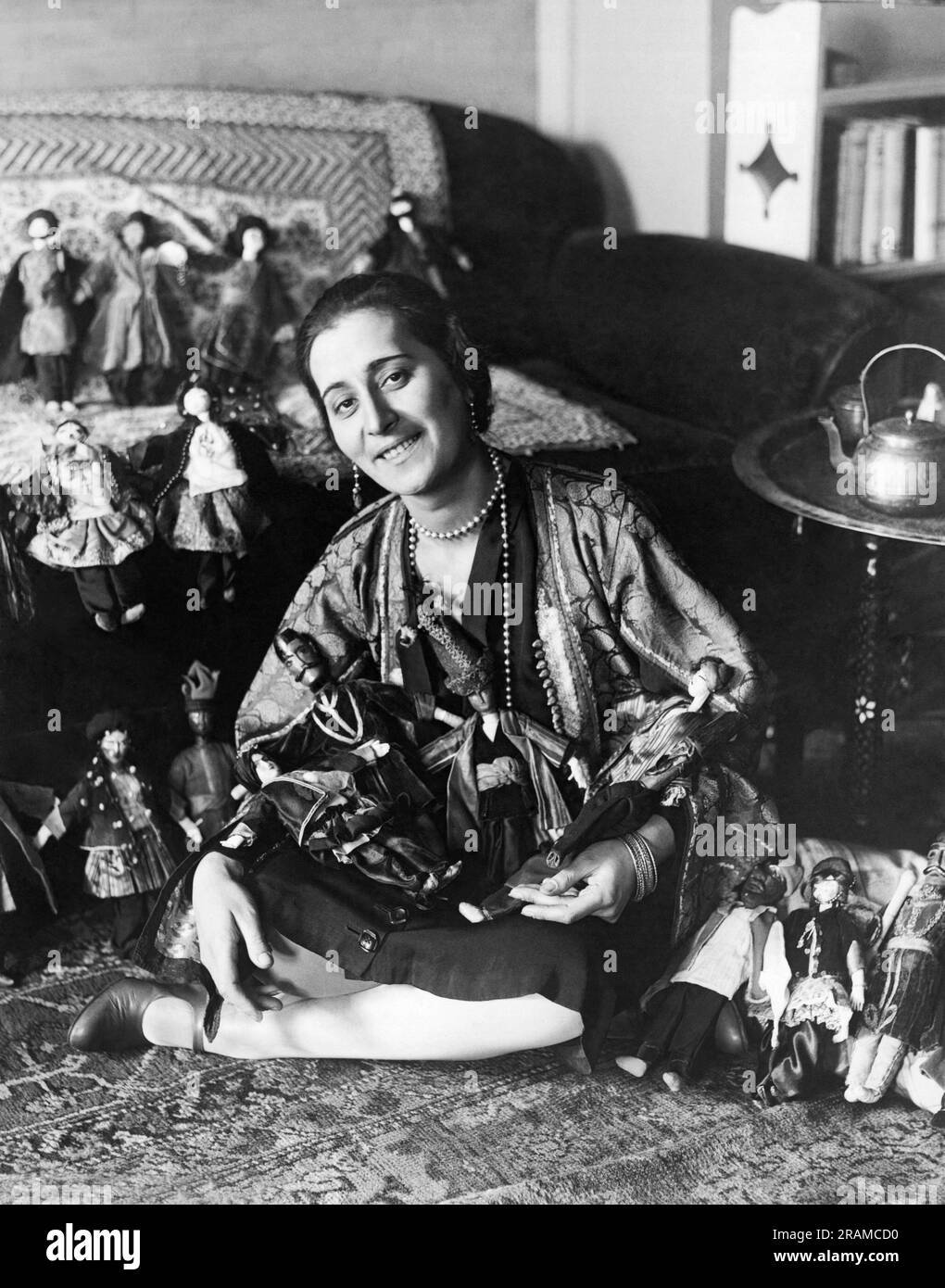 Philadelphia, Pennsylvania:  October 21, 1926 A Persian woman, member of the Persian Commision, and the first to discard the traditional veil of the country, Zorah Khanoum Herdary is at the Sesquicentennial Exposition exhibiting some of the dolls at the Persian exhibit. Some of them are several hundred years old. Stock Photo