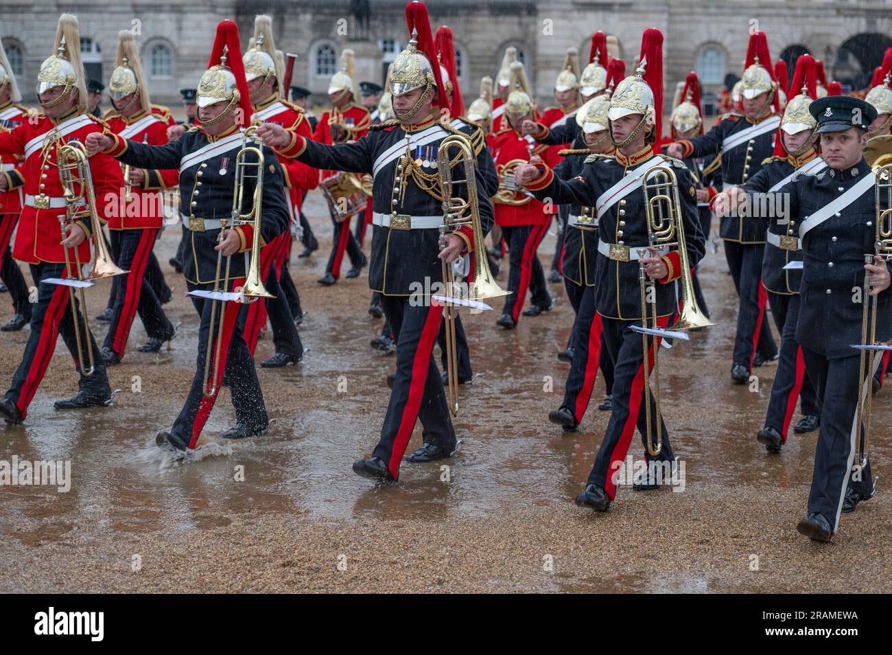 Horse Guards Parade, London, UK. 4th July, 2023. First night of Orb and Sceptre military musical spectacle, open to the public, takes place in heavy rain and features the Bands of the Household Divisions, The Pipes and Drums of the Royal Yeomanry and the King's Troop Royal Horse Artillery in a rain soaked Horse Guards Parade but with a packed audience. Credit: Malcolm Park/Alamy Live News Stock Photo