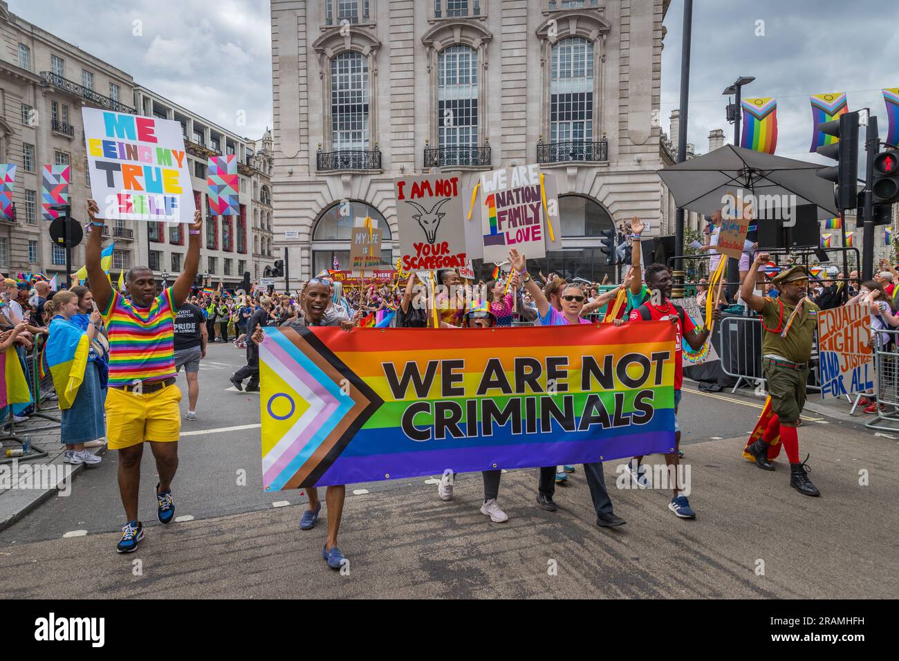 Progress flag stating 'we are not criminals' during the Pride in London parade Stock Photo