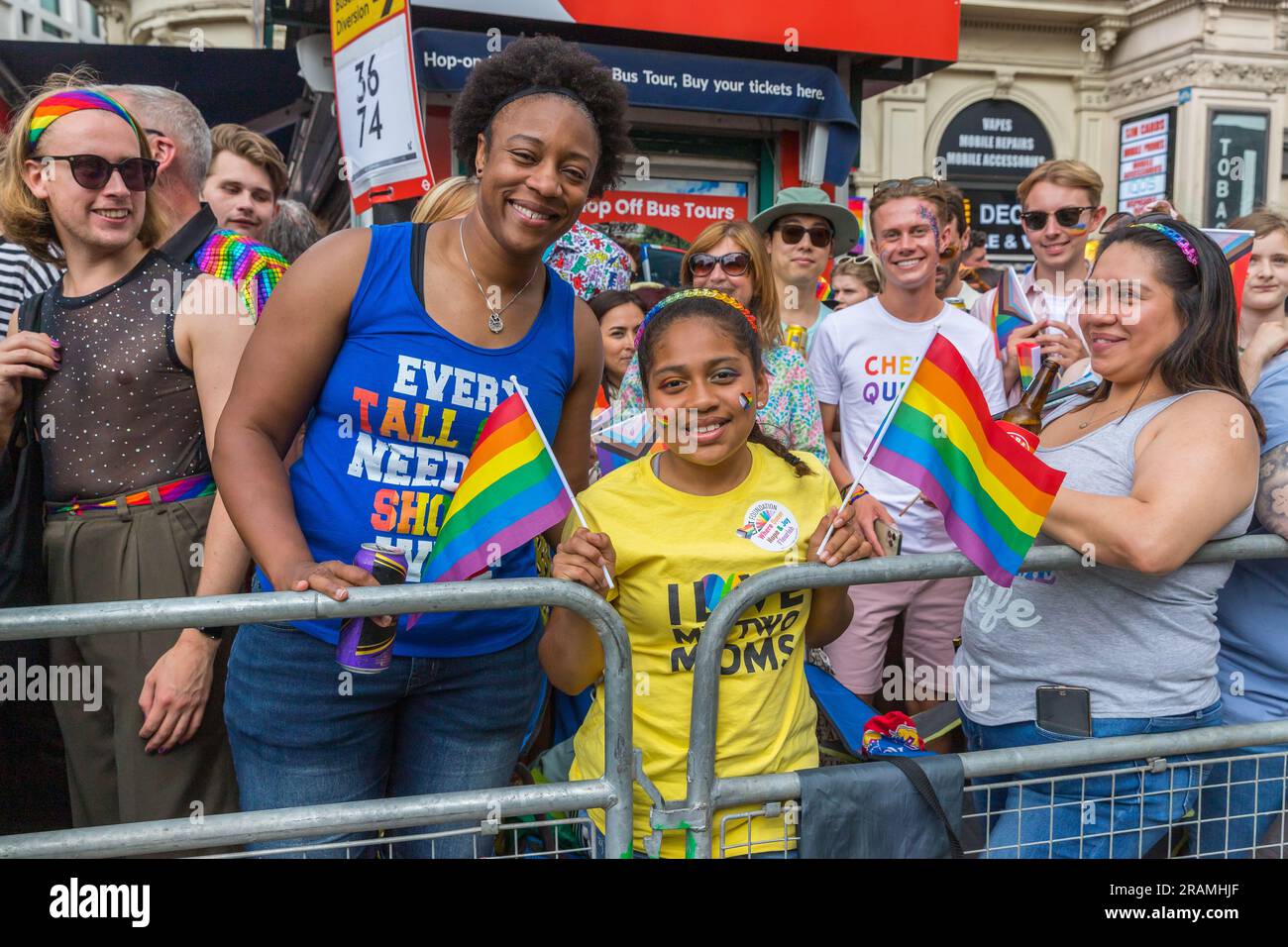 Black mother and daughter with rainbow flags at the Pride in London ...