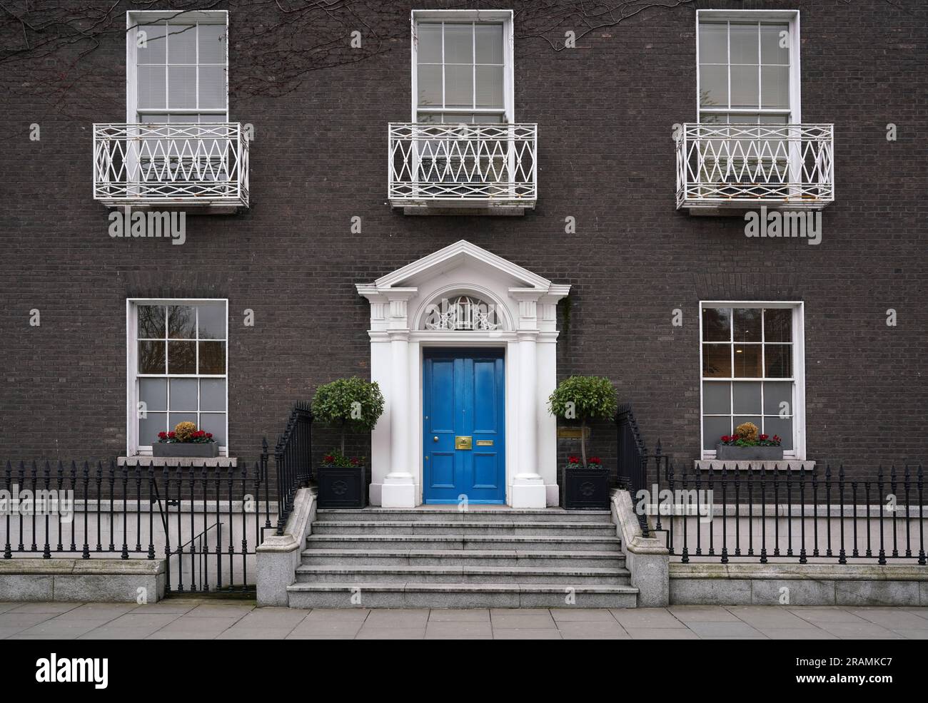 Old fashioned Georgian style townhouse with bright blue front door Stock Photo