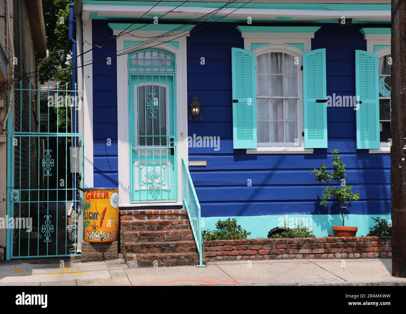 Quaint wooden blue Creole cottage with bright blue shutters, Faubourg Marigny district, New Orleans. Stock Photo