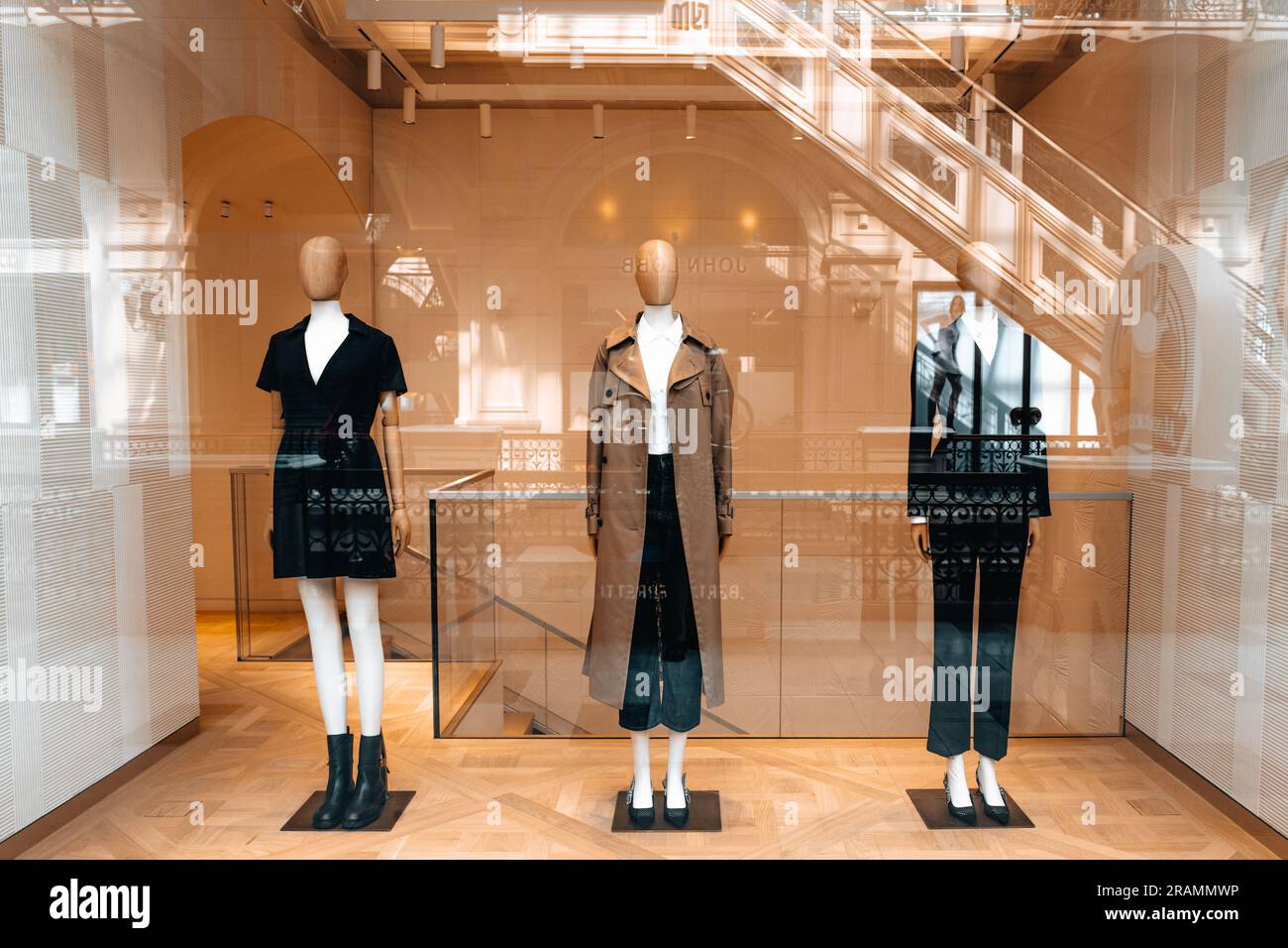 Mannequins dressed in a stylish fashionable autumn winter collection. Long brown coat, black dress, classy costume Stock Photo