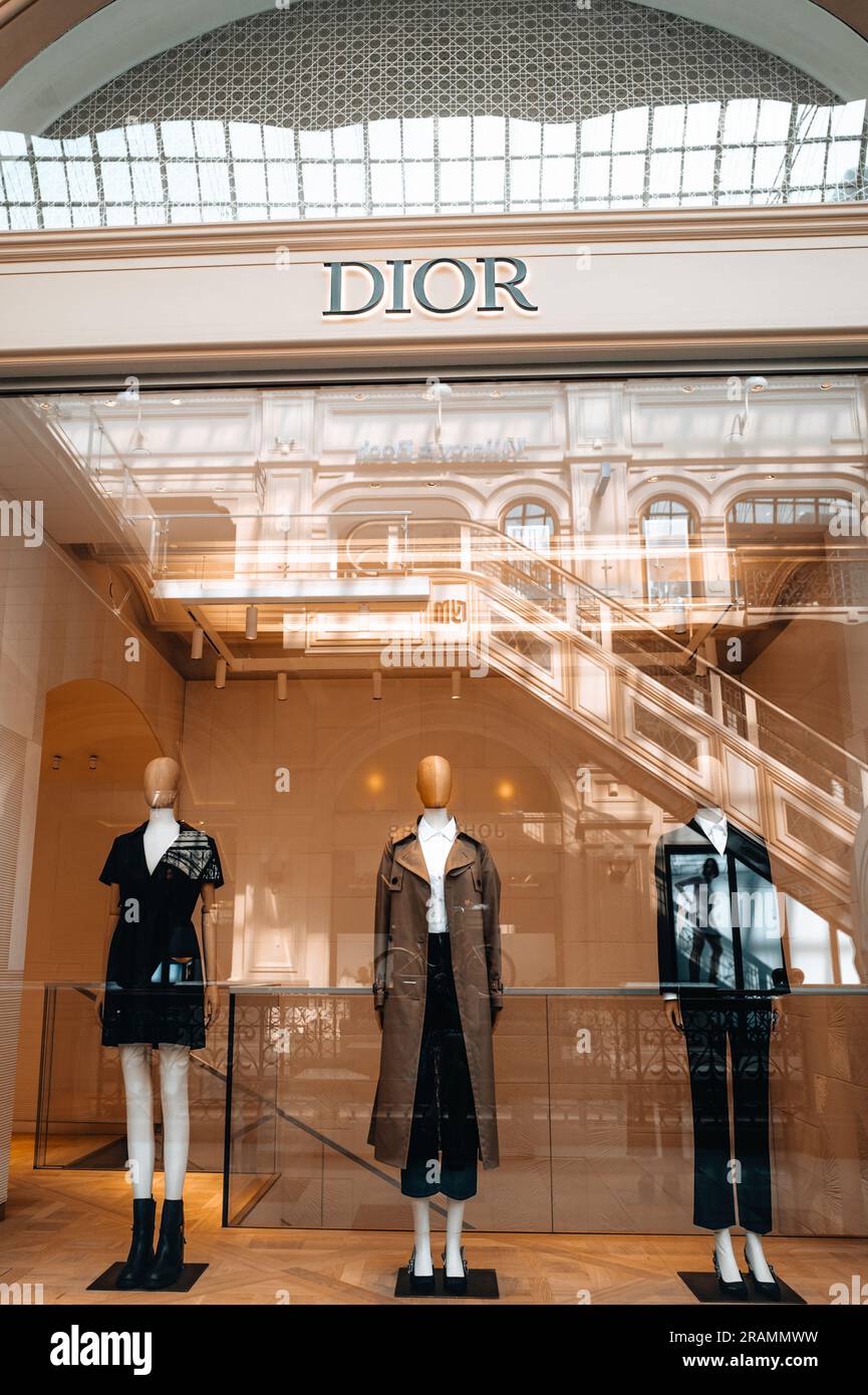 Dior logo and mannequins in a shop window dressed in a stylish fashionable autumn winter collection. Dior is a fashion house founded in Paris speciali Stock Photo