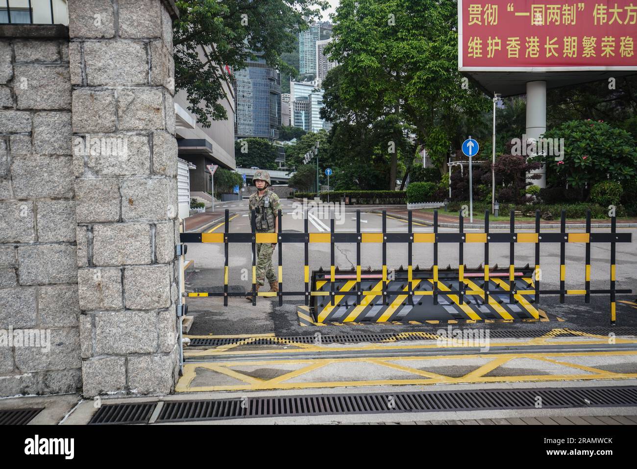 A soldier stands on guard at the entrance gate of the Chinese People's Liberation Army Forces Hong Kong Building in Hong Kong. The Central Barracks Amethyst Block is one of the barracks of Chinese People's Liberation Army basement, it is located next to the Central Government Offices. Stock Photo