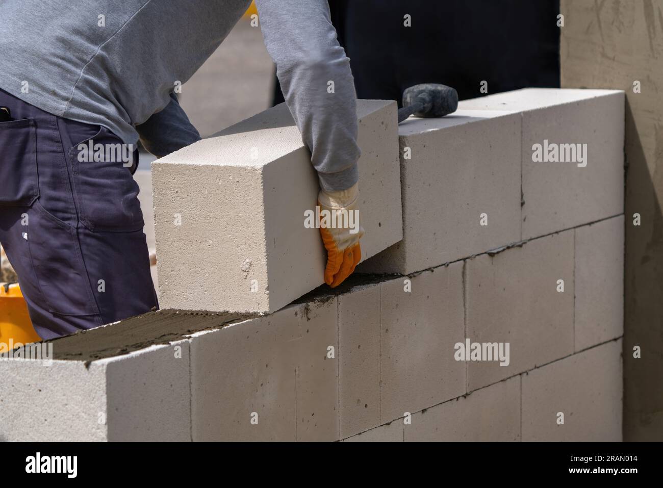 The bricklayer is working. Building a wall of aerated concrete. Stock Photo