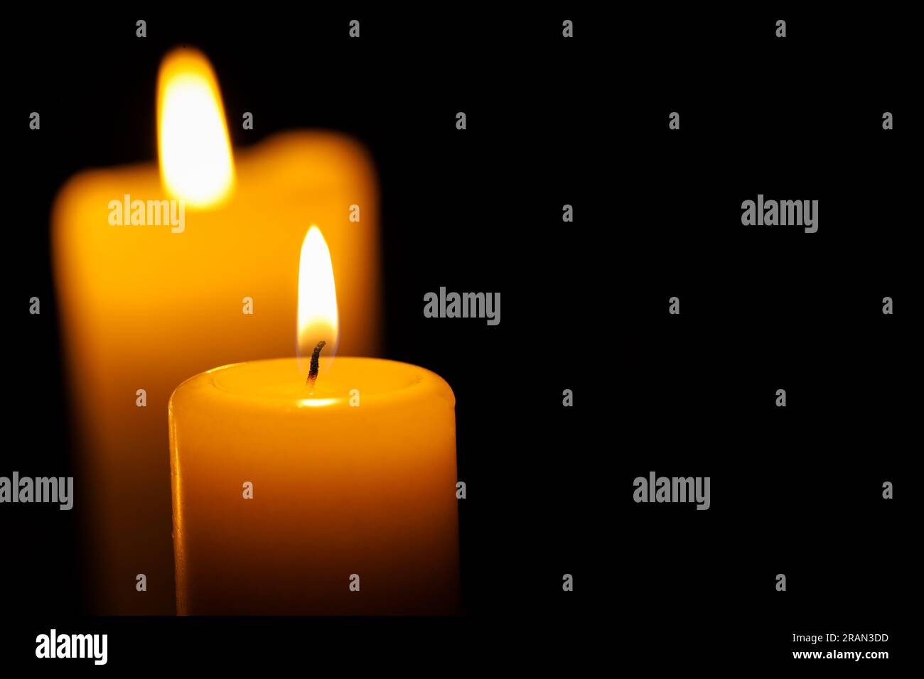 Burning candles on black background, closeup. Space for text Stock ...