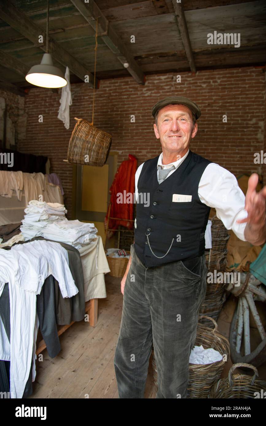 man doing role play at the steam laundry at the Zuiderzee Musuem Stock Photo
