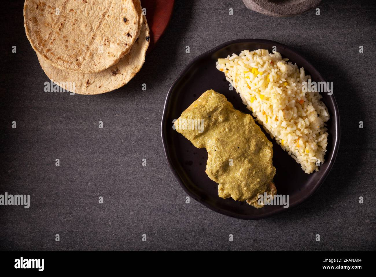 Pipian, also known as Mole Verde, food from Mexico and other Latin American countries, chicken meat bathed in mole sauce made with pumpkin seeds, drie Stock Photo