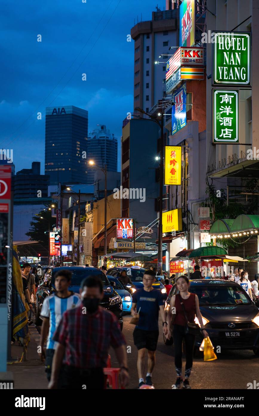 Kuala Lumpur, Malaysia - July 1, 2023: Street scene of KL Chinatown during evening, dusk hour. Chinatown is very popular for eatery and shopping among Stock Photo