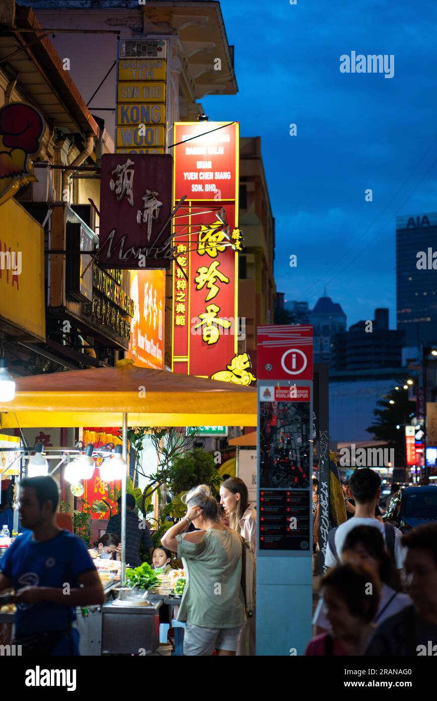 Kuala Lumpur, Malaysia - July 1, 2023: Street scene of KL Chinatown during evening, dusk hour. Chinatown is very popular for eatery and shopping among Stock Photo