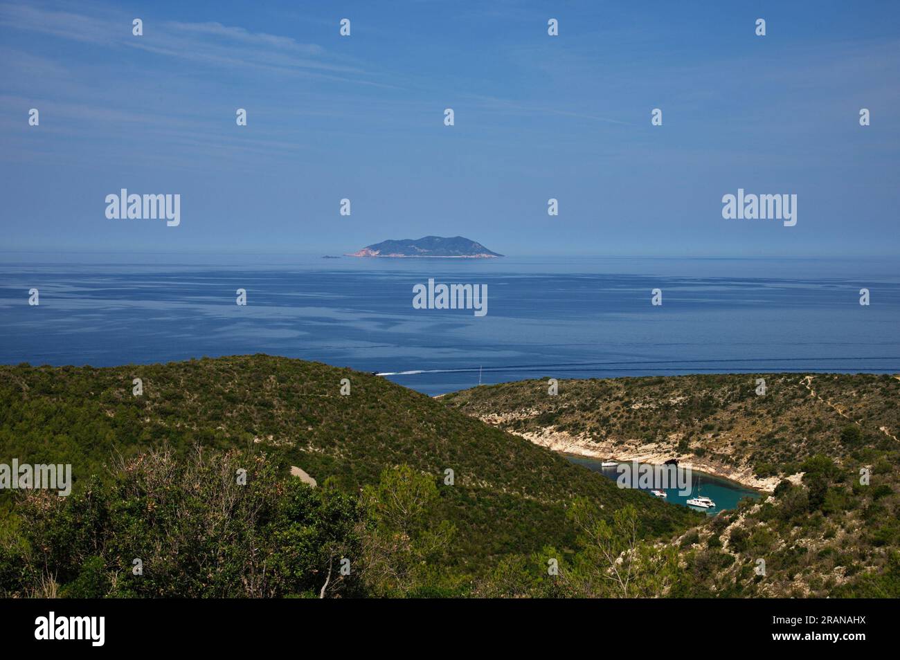 High angle view of deep bay in Adriatic sea with sailboats anchored in clear blue water Stock Photo