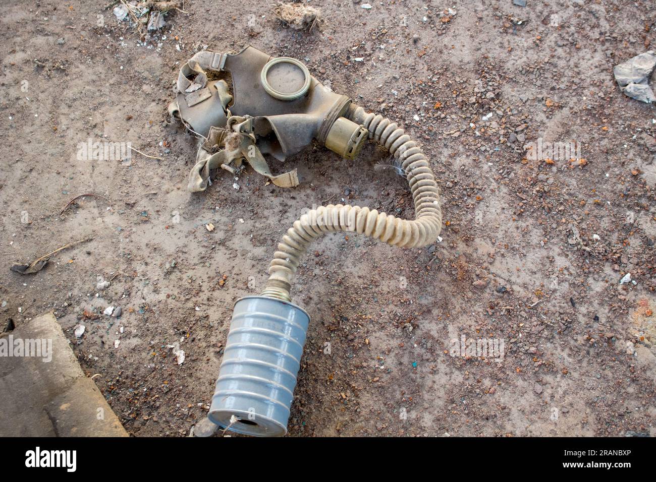 Discharged old gas mask with a filter in the abandoned factory Stock