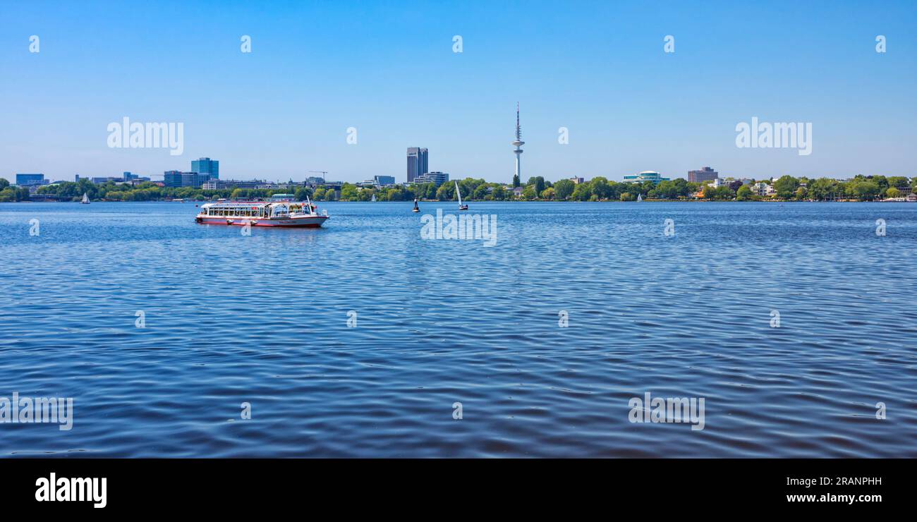Panorama of Alster lake at Hamburg from Kennedybrücke to Alte Rabenstrasse, tourist boat in front Stock Photo