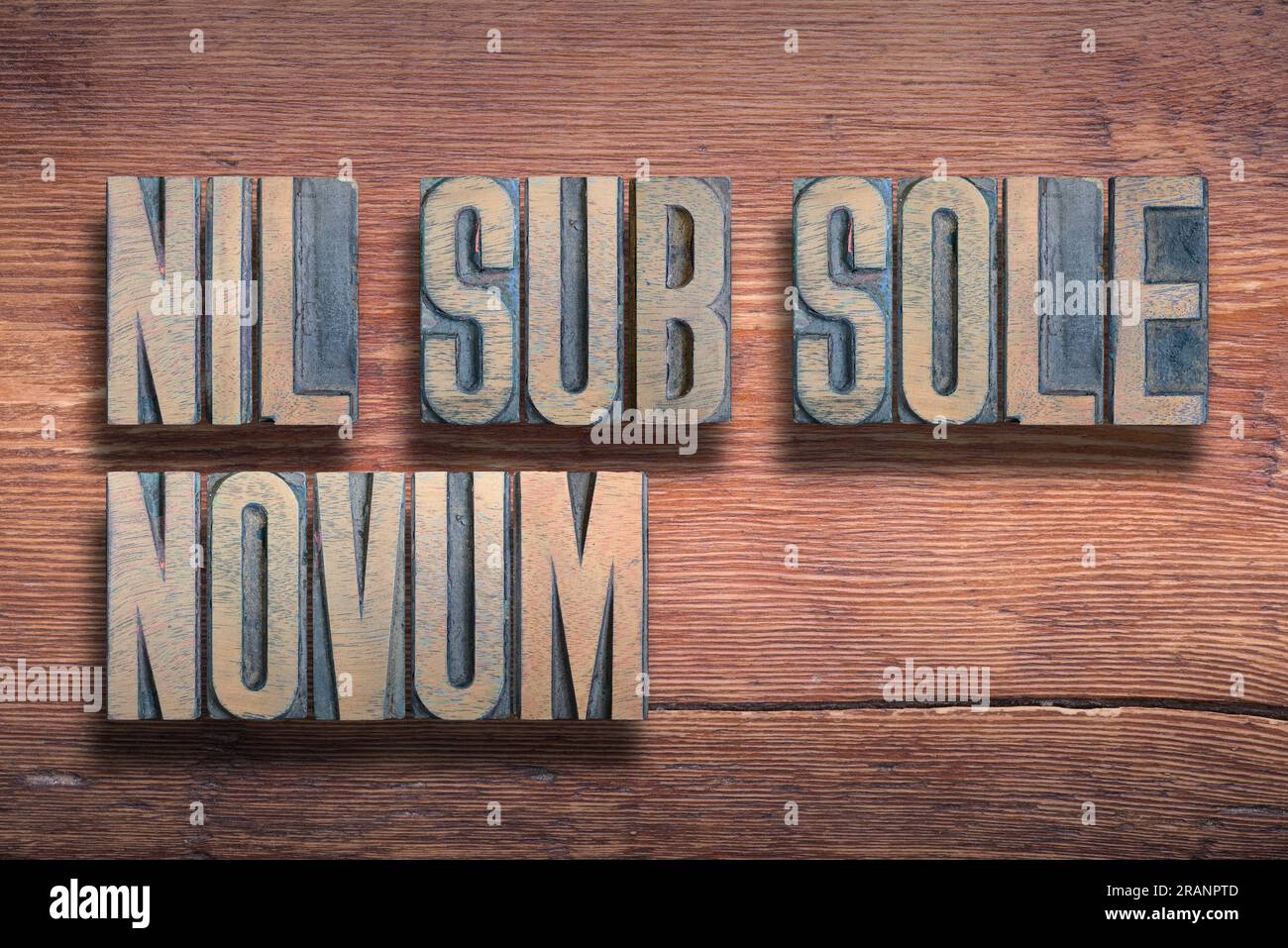 Nil sub sole novum, ancient Latin phrase meaning, Nothing is new under the sun, combined on vintage varnished wooden surface Stock Photo
