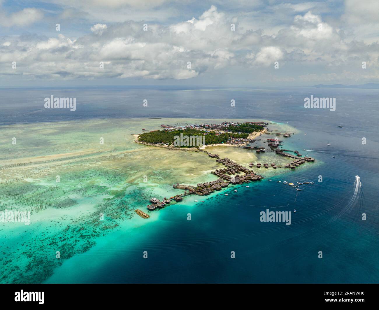 Aerial drone of tropical island of Mabul with a beautiful beach and coral reef. Semporna, Sabah, Malaysia. Stock Photo