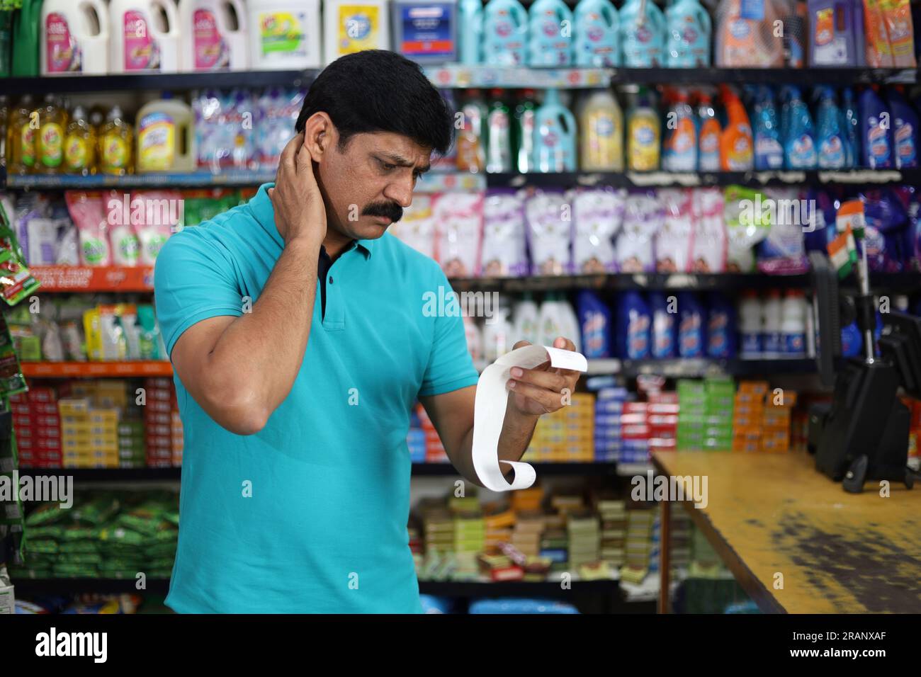 Boy standing in front of the product counter in a grocery store. Boy