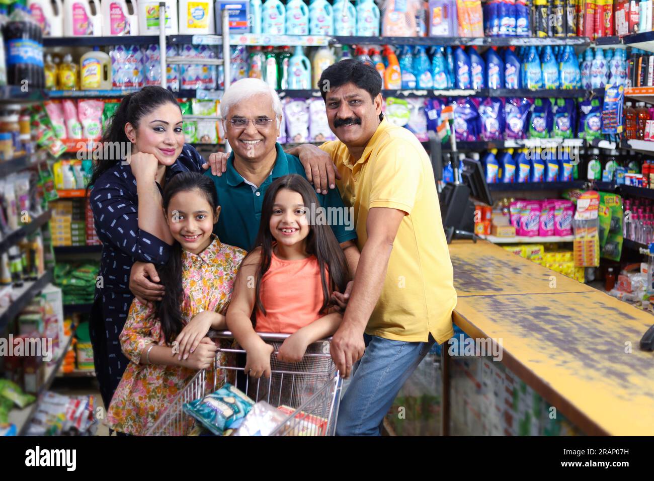 happy family shopping in grocery store and supermarket. They are looking for desired products they need to purchase. Stock Photo