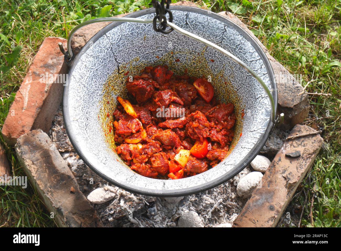 Making Hungarian Gulyas in a cauldron, Bogracs, , in the garden, Szigethalom, Hungary Stock Photo