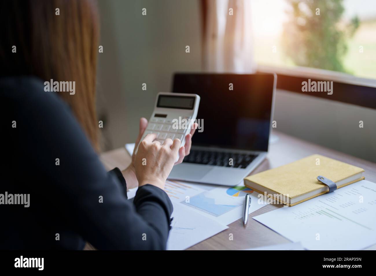 businesswoman or accountant working on calculator and laptop computer ...