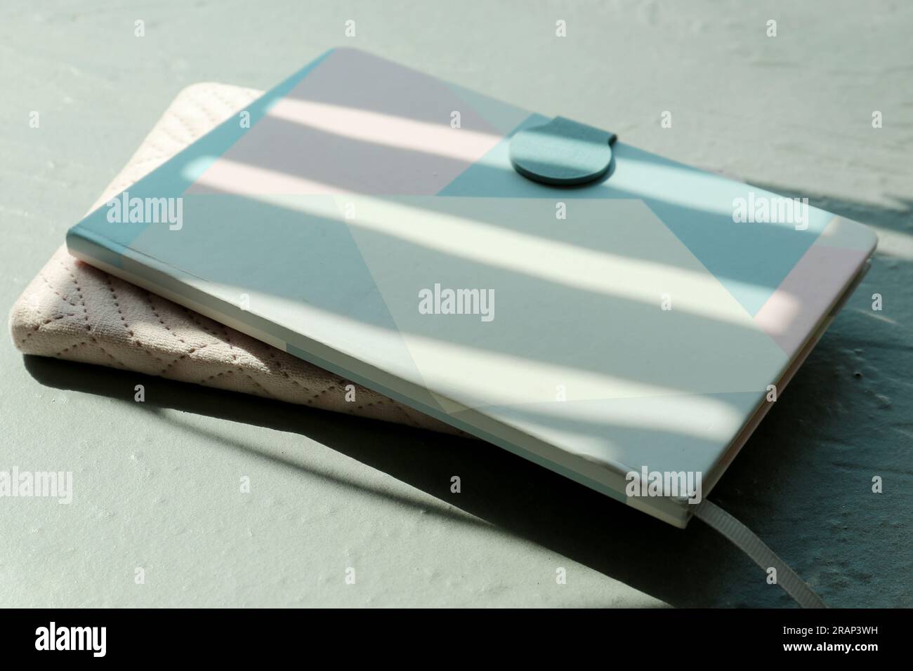 Two notebooks with shadows on grey background Stock Photo
