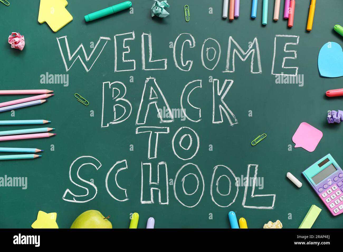Different stationery with text WELCOME BACK TO SCHOOL on green ...