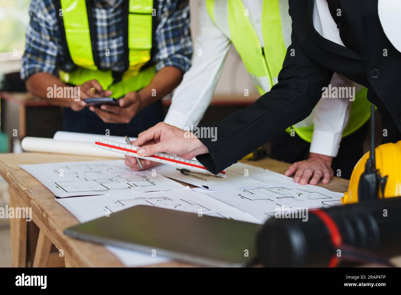 multi ethnic engineer brainstorming and measuring for cost estimating