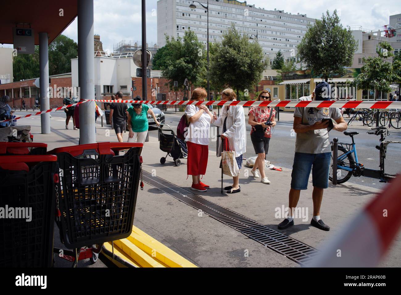 Monoprix, 9 Rue Louise Thuliez, Place de Fêtes, 75019, Paris, France, 30th June, 2023. People look on, after a Monoprix store is attacked after a third night of violence and riots over the police killing of a teenager on Tuesday evening in Nanterre a suburb of Paris. Credit: Jane Burke/Alamy Live News. Stock Photo