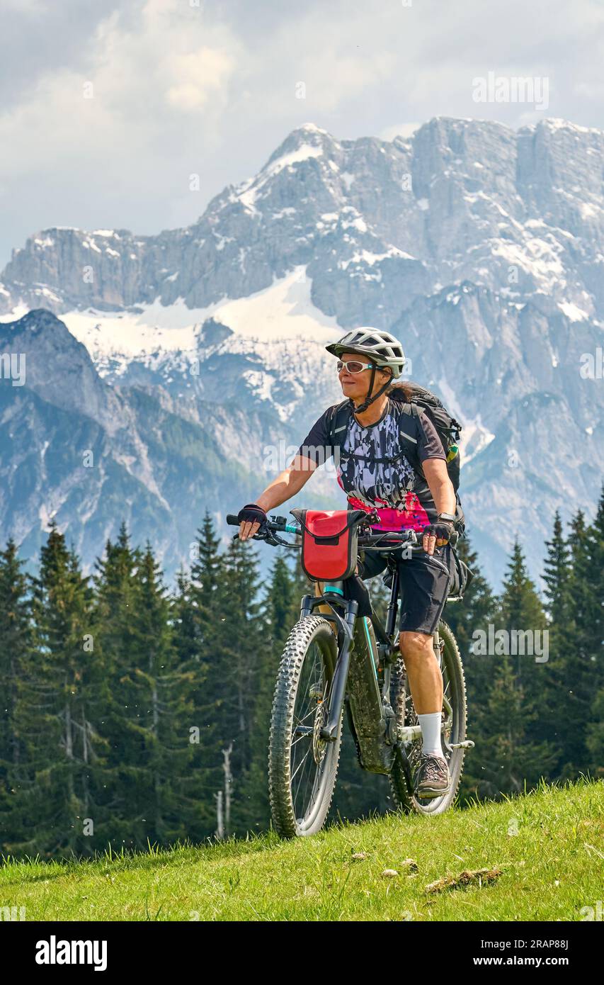 active senior woman on a mountain bike tour in the Julian Alps above Kranska Gora in Slovenia Stock Photo