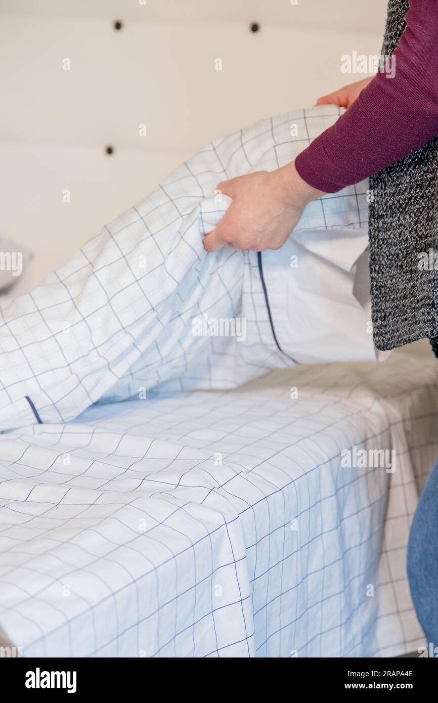 Detail of person making the bed. Concept of home life, daily activities